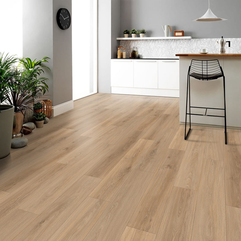 Floating laminate flooring in a modern kitchen with a bar stool and plants.